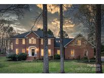 Charming brick two-story home with manicured lawn, elegant entryway, and inviting curb appeal at 5750 Hemby Rd, Matthews, NC 28104