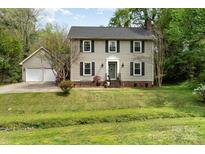 Charming two-story home with traditional design, a well-manicured lawn and an attached two car garage at 608 Grace St, Shelby, NC 28150