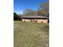 Charming brick ranch-style home with a well-maintained lawn and mature trees at 736 Lawndale Cir, Fort Lawn, SC 29714