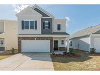 Charming two-story home featuring a two-car garage, brick accents and a well-maintained lawn at 1121 Red River Dr, Salisbury, NC 28144
