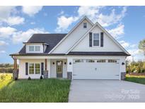 Charming new construction home features a white exterior, black shutters, and a two-car garage at 120 Southern Oaks Ln, Salisbury, NC 28147