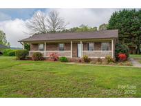 Well-kept brick home featuring a covered front porch and neatly manicured lawn at 1663 Smyre Farm Rd # 5, Newton, NC 28658