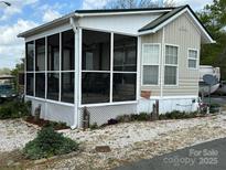 Charming manufactured home with a screened porch and well-maintained landscaping at 171 Grand View Dr, New London, NC 28127