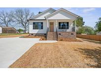 Charming home with a brick foundation, inviting porch, and newly laid lawn at 203 E 27Th St, Kannapolis, NC 28083