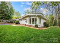 Charming single-story home with well-maintained lawn and mature trees in a desirable neighborhood at 2239 Wensley Dr, Charlotte, NC 28210