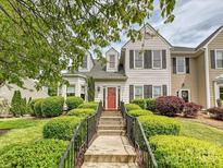 Charming townhouse with a landscaped front yard and a striking red front door at 2516 Middlebridge Ln, Charlotte, NC 28270