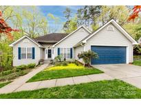 Charming single-story home with a well-maintained lawn, blue shutters, and attached garage on a sunny day at 3505 Mayspring Pl, Charlotte, NC 28269