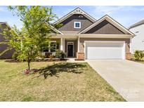 Charming single-Gathering home featuring a two-car garage and landscaped front yard at 7633 Tanglewood Way, Denver, NC 28037