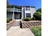 A charming condominium building with a second story balcony and landscaped entrance at 11015 Harrowfield Rd, Charlotte, NC 28226