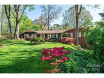Charming single-story home featuring a lush lawn and colorful landscaping at 1213 10Th Street Nw Ln # 3, Hickory, NC 28601