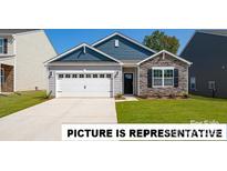 Charming single-story home featuring stone accents, a two-car garage, and a well-maintained lawn at 127 Way Cross Ln, Troutman, NC 28166