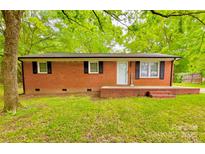 Charming brick home featuring a welcoming front porch and a classic, clean design at 1780 Short St, Mount Pleasant, NC 28124