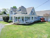 Charming blue two-story home with a welcoming front porch and well-manicured lawn at 3241 Long Shoals Rd, Lincolnton, NC 28092