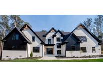 Elegant home with a white brick facade, black trim, and striking architectural details at 3268 Sherman Dr, Lancaster, SC 29720