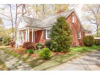 Charming brick home with a well-maintained front yard, mature trees, and inviting front porch at 920 N Sixth St, Albemarle, NC 28001