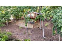 Beautiful home featuring a deck, lower patio, and lake views at 119 Harbor Ln, Mount Gilead, NC 27306