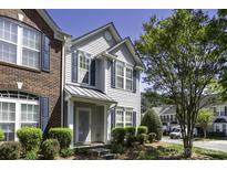 Charming townhouse featuring a blend of brick and siding, complemented by well-maintained landscaping and a welcoming entrance at 121 Talbert Town Loop, Mooresville, NC 28117