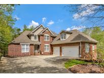 Charming brick home featuring a well-manicured lawn, a two-car garage, and a welcoming entrance at 1427 Doe Ridge Ln, Fort Mill, SC 29715