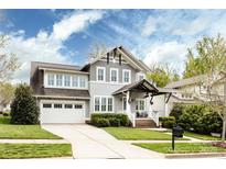 Charming two-story home featuring a well-manicured lawn, two-car garage, and inviting front porch at 1550 Matthew Mcclure Cir, Davidson, NC 28036