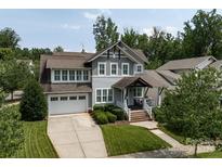 Charming home with a two-car garage, well-manicured lawn, and covered front porch at 1550 Matthew Mcclure Cir, Davidson, NC 28036