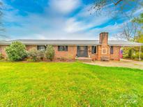 Charming brick ranch home featuring a spacious front yard and a convenient covered carport at 1910 York Hwy, York, SC 29745