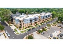 A modern apartment complex with blue and beige exterior and well-maintained landscaping at 2401 Euclid Ave, Charlotte, NC 28203