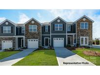 Charming townhome exterior with stone accents, a driveway, and a single-car garage at 533 Trading Post Ln, York, SC 29745