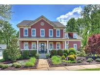 Charming two-story home featuring a welcoming front porch and beautifully landscaped front yard at 727 Bluff Loop Rd, Rock Hill, SC 29730
