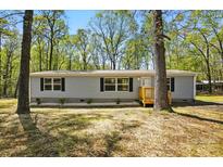 Charming single-story home featuring gray siding, black shutters and a small wooden porch at 110 Matthew Dr, Kings Mountain, NC 28086