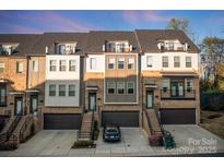 Beautiful townhome with brick accents, attached garages, and individual staircases leading to private entrances at 11039 Stetler St, Charlotte, NC 28204