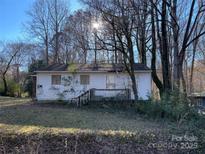 Charming single-story home with a covered front porch and mature trees in a serene setting at 119 Lineberger St, Stanley, NC 28164