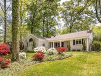Beautiful home with lush landscaping and a well-manicured lawn at 1310 Woodland Dr, Charlotte, NC 28205
