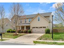 Traditional two-story home featuring manicured landscaping and a two car garage at 2065 Taney Way, Indian Land, SC 29707