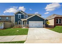 Beautiful two-story home with a two-car garage, well-manicured lawn and a charming exterior at 2573 Blue Sky Meadows Dr, Monroe, NC 28110