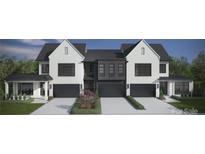 Modern townhouse exterior featuring white brick, black trim, and a well-manicured lawn at 2924 Sharon View Rd # B, Charlotte, NC 28210