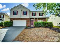 Charming two-story home featuring brick accents, red shutters, well-maintained landscaping, and a two-car garage at 3619 Grove Creek Pond Sw Dr, Concord, NC 28027