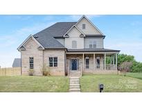 Charming two-story brick home with a welcoming front porch and well-manicured lawn at 4036 Meadowview Hills Dr # 7, Charlotte, NC 28269