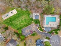 Aerial view of community amenities including a pool, playground, and parking area surrounded by greenery at 609 Tysons Forest Dr, Rock Hill, SC 29732