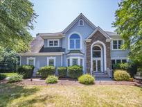 Inviting front exterior of home with stone accents, well-maintained landscaping, and a welcoming entrance at 6123 Glen Manor Dr, Charlotte, NC 28269