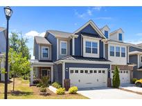 Charming two-story home featuring a two-car garage, blue siding, and a well-manicured front lawn at 637 Amber Meadows Way, Fort Mill, SC 29708