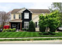 Charming two-story home with a well-manicured lawn and mature landscaping, presenting a welcoming curb appeal at 8140 Laurel Run Dr, Charlotte, NC 28269