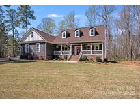 Charming home featuring a manicured lawn, inviting front porch and dormer windows at 1016 Secretariat Dr, York, SC 29745