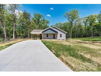 Charming single-story home with a convenient carport and a newly installed concrete driveway at 102 Kerda St, Taylorsville, NC 28681