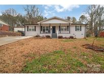 Charming single-story home with a covered front porch and black shutters at 140 Wandering Ln, Bessemer City, NC 28016
