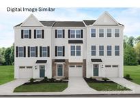 Charming townhome exterior with classic architectural details, manicured lawn and private garage for modern living at 2532 Ellen Ave # 1001F, Charlotte, NC 28208