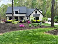 Charming home with a manicured lawn and landscaping, highlighting curb appeal and a welcoming entrance at 2656 Lee Lawing Rd, Lincolnton, NC 28092