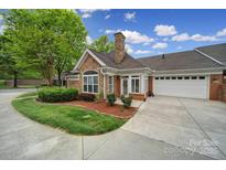 Charming stone and brick home with well-maintained landscaping and a two-car garage at 2959 Bellasera Way, Matthews, NC 28105