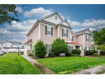 Charming townhome with well-maintained lawn and landscaping, showcasing curb appeal and inviting entrance at 4133 Carl Parmer Dr, Harrisburg, NC 28075