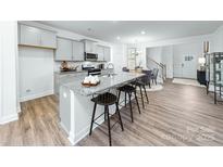 Modern kitchen boasts an island with a granite countertop and stainless steel appliances at 4240 Steel Way, Sherrills Ford, NC 28673