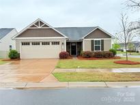 Charming single-story home with manicured lawn and attached two-car garage at 531 Cherry Blossom Nw Ave, Concord, NC 28027
